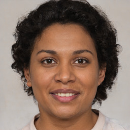 Joyful black adult female with short  brown hair and brown eyes