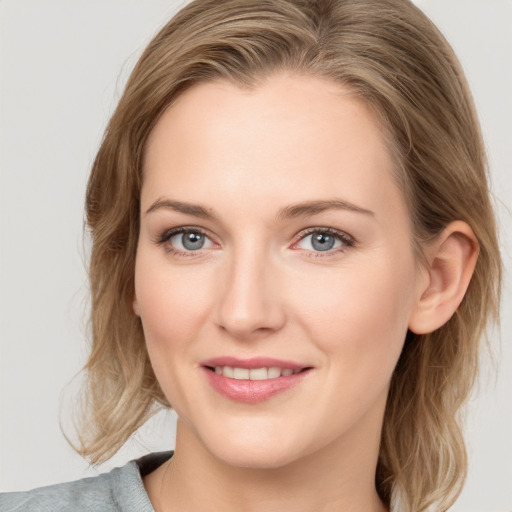 Joyful white young-adult female with medium  brown hair and blue eyes