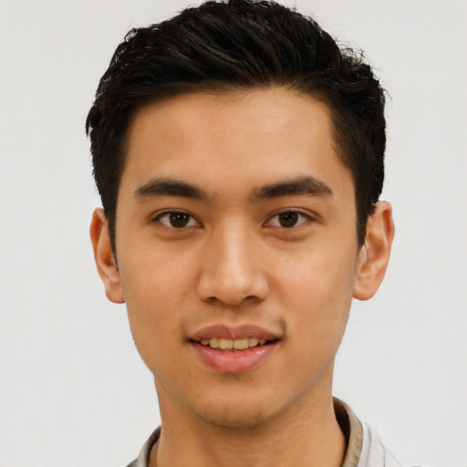 Joyful latino young-adult male with short  brown hair and brown eyes