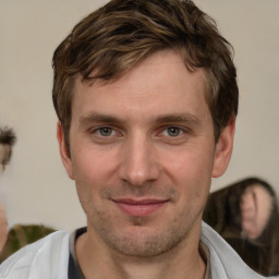 Joyful white adult male with short  brown hair and brown eyes