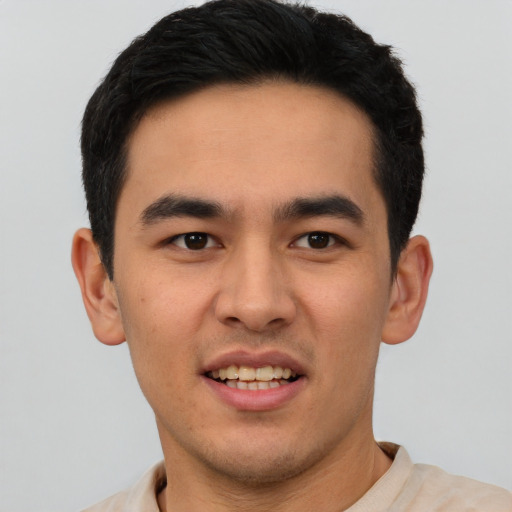 Joyful white young-adult male with short  black hair and brown eyes