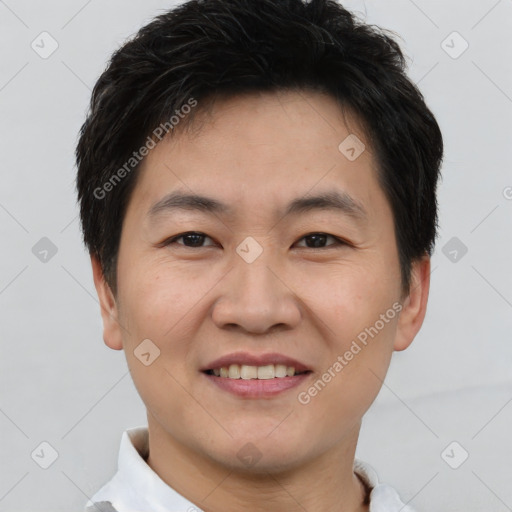 Joyful asian young-adult male with short  brown hair and brown eyes