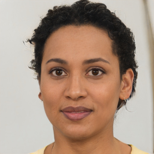 Joyful latino young-adult female with short  brown hair and brown eyes