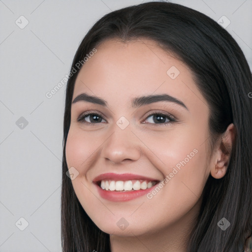 Joyful white young-adult female with long  black hair and brown eyes