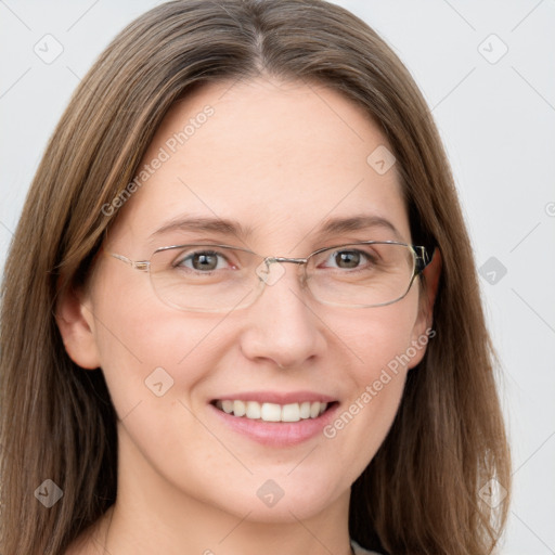 Joyful white adult female with long  brown hair and grey eyes