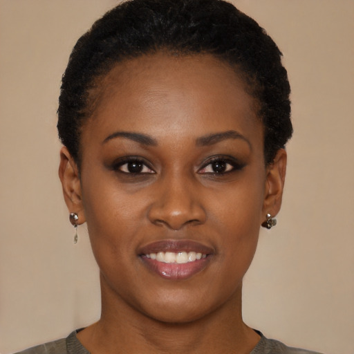 Joyful black young-adult female with short  black hair and brown eyes