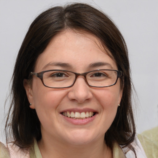 Joyful white adult female with medium  brown hair and brown eyes