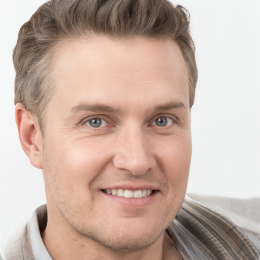 Joyful white adult male with short  brown hair and grey eyes