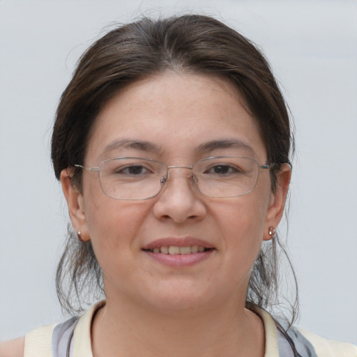 Joyful white adult female with medium  brown hair and brown eyes