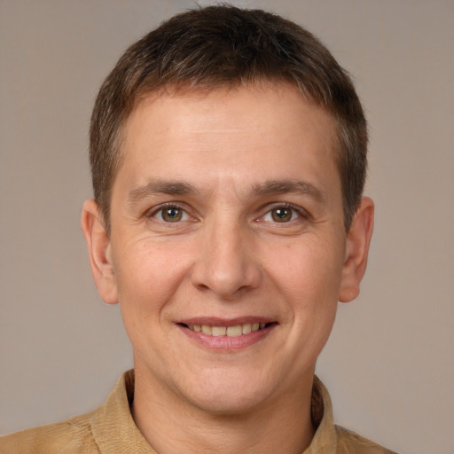 Joyful white adult male with short  brown hair and brown eyes