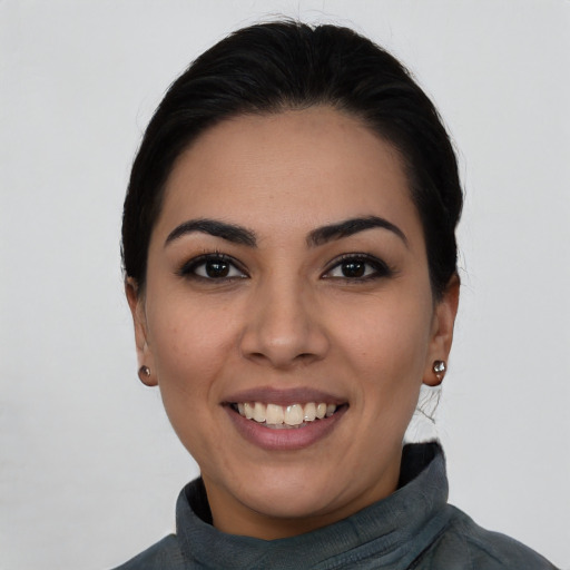 Joyful latino young-adult female with medium  black hair and brown eyes