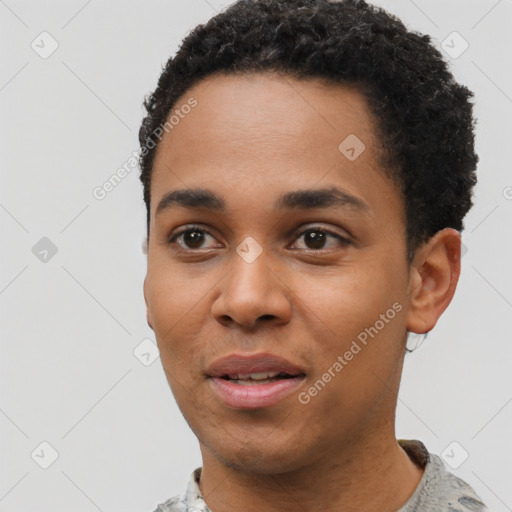 Joyful black young-adult male with short  black hair and brown eyes