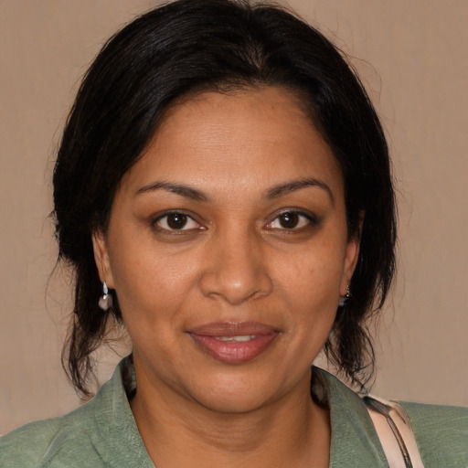 Joyful black adult female with medium  brown hair and brown eyes