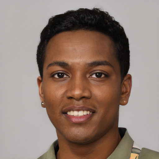 Joyful black young-adult male with short  black hair and brown eyes