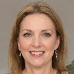 Joyful white adult female with medium  brown hair and grey eyes