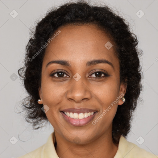 Joyful black young-adult female with medium  brown hair and brown eyes