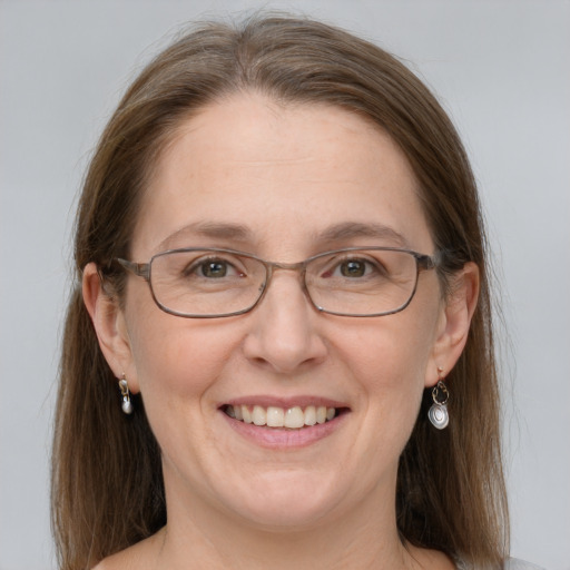 Joyful white adult female with medium  brown hair and grey eyes