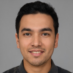 Joyful white young-adult male with short  black hair and brown eyes