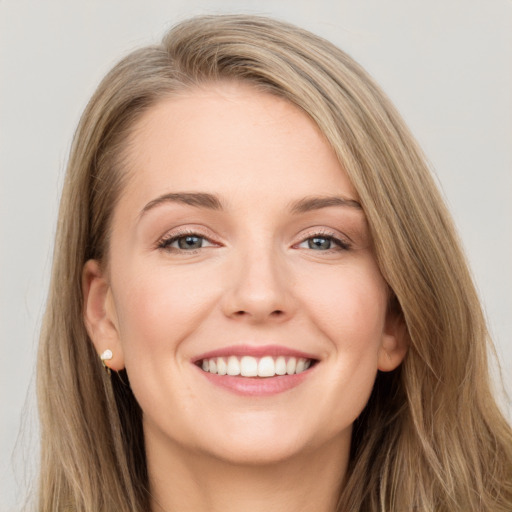 Joyful white young-adult female with long  brown hair and grey eyes