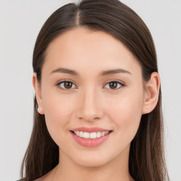 Joyful white young-adult female with long  brown hair and brown eyes