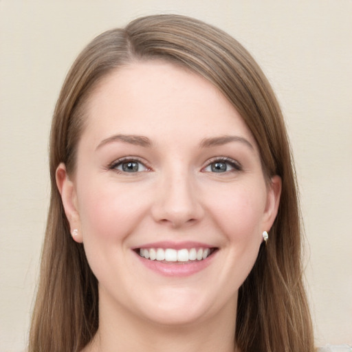 Joyful white young-adult female with long  brown hair and grey eyes