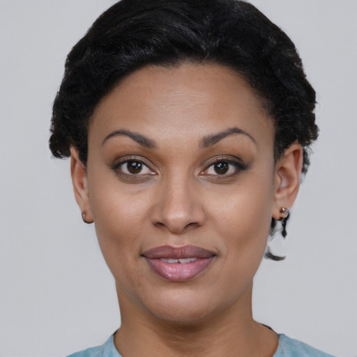 Joyful black young-adult female with short  black hair and brown eyes