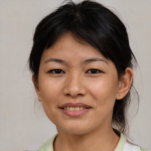 Joyful asian young-adult female with medium  brown hair and brown eyes