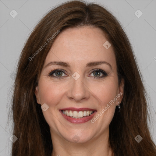 Joyful white adult female with long  brown hair and brown eyes