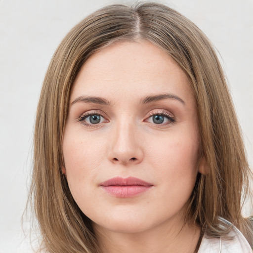 Joyful white young-adult female with long  brown hair and green eyes