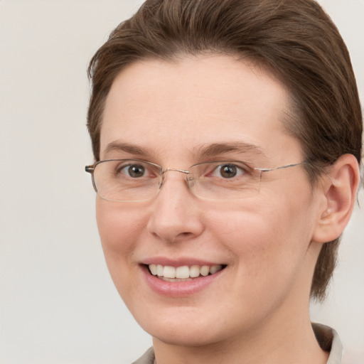 Joyful white adult female with short  brown hair and grey eyes