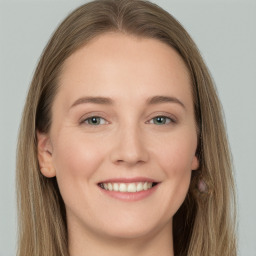 Joyful white young-adult female with long  brown hair and grey eyes