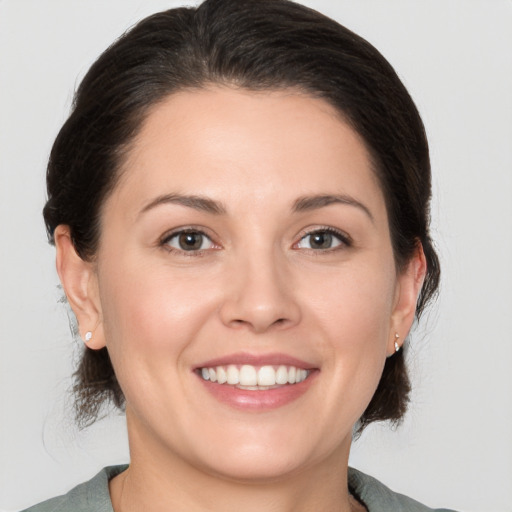 Joyful white young-adult female with medium  brown hair and brown eyes