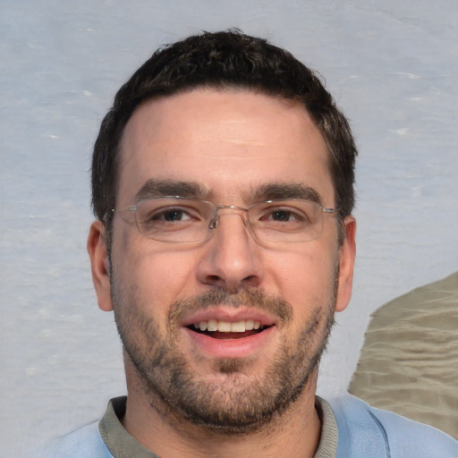 Joyful white young-adult male with short  black hair and brown eyes