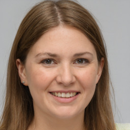 Joyful white young-adult female with long  brown hair and grey eyes