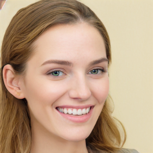 Joyful white young-adult female with long  brown hair and green eyes