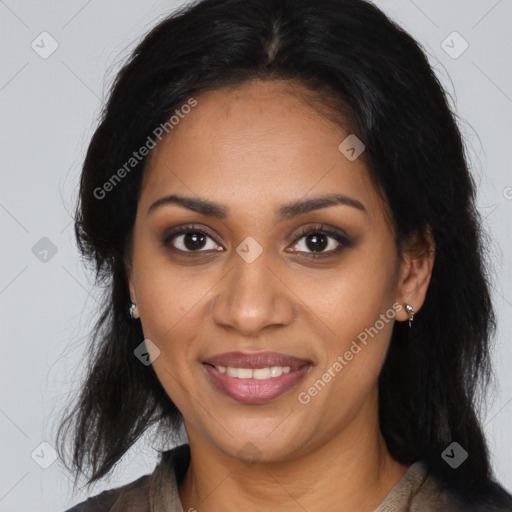 Joyful black young-adult female with long  brown hair and brown eyes