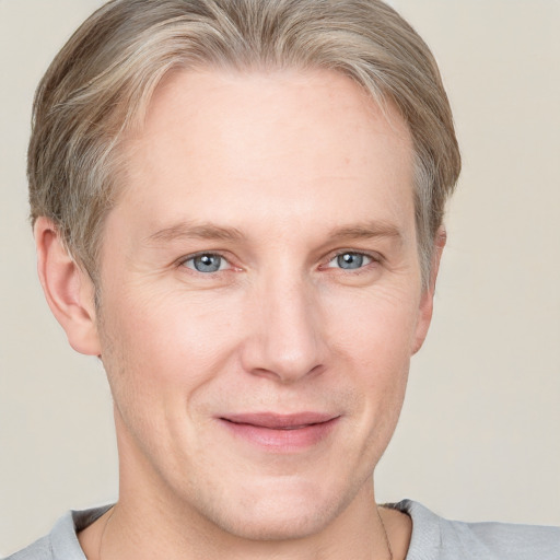 Joyful white adult male with short  brown hair and grey eyes