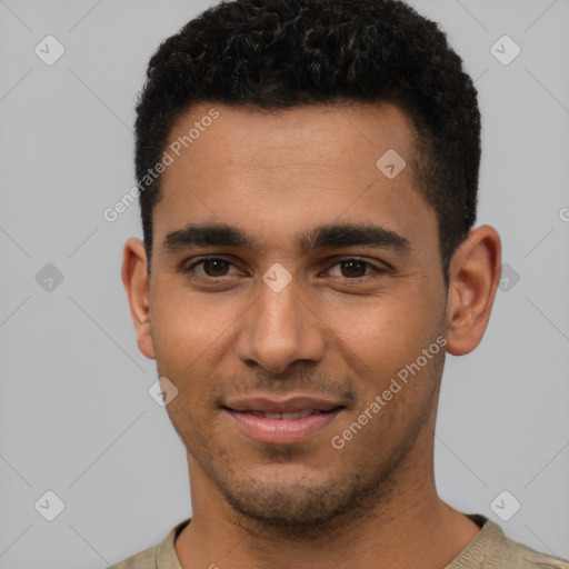 Joyful latino young-adult male with short  brown hair and brown eyes