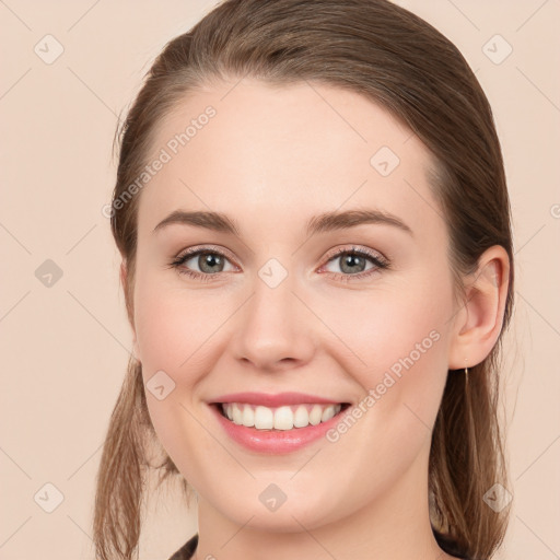 Joyful white young-adult female with long  brown hair and green eyes