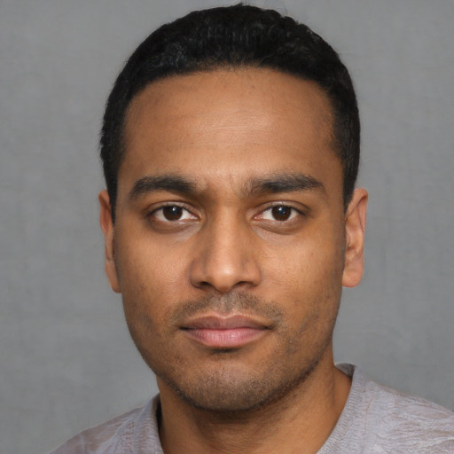 Neutral latino young-adult male with short  black hair and brown eyes