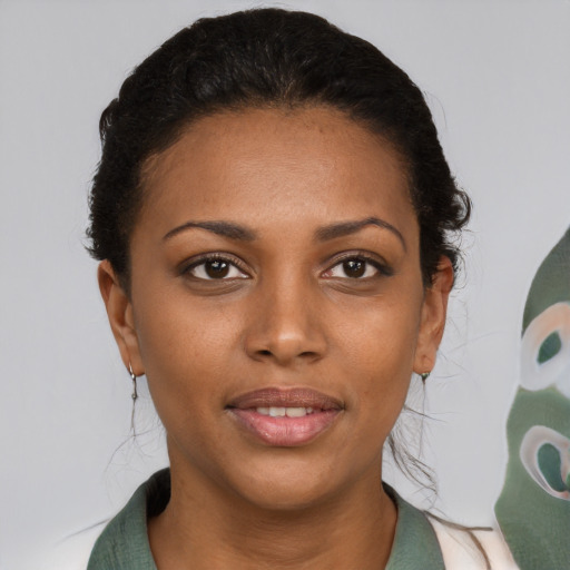 Joyful black young-adult female with medium  brown hair and brown eyes