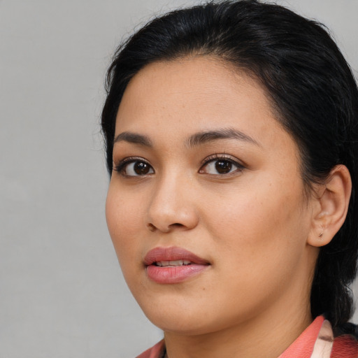 Joyful asian young-adult female with medium  brown hair and brown eyes