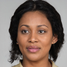 Joyful black adult female with medium  brown hair and brown eyes