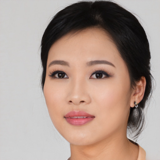 Joyful asian young-adult female with medium  black hair and brown eyes