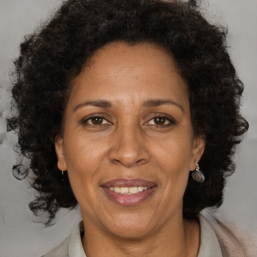 Joyful black adult female with medium  brown hair and brown eyes