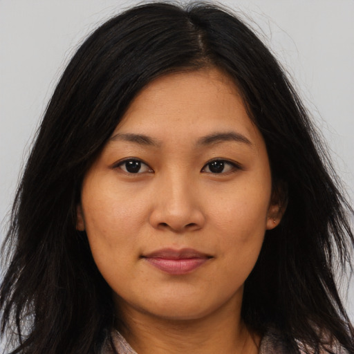 Joyful asian young-adult female with long  brown hair and brown eyes