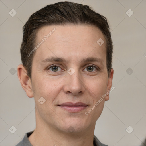 Joyful white adult male with short  brown hair and grey eyes