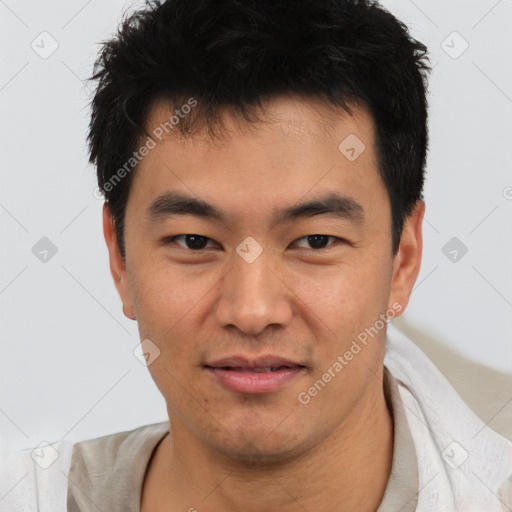 Joyful asian young-adult male with short  black hair and brown eyes