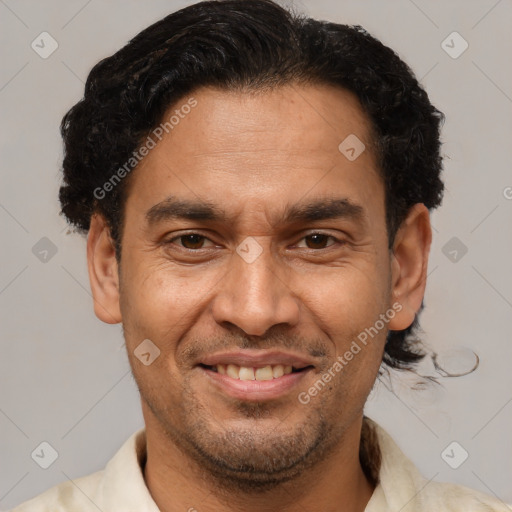 Joyful latino adult male with short  brown hair and brown eyes