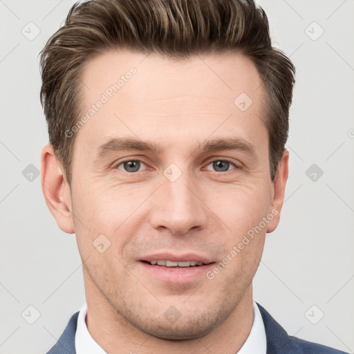 Joyful white young-adult male with short  brown hair and grey eyes